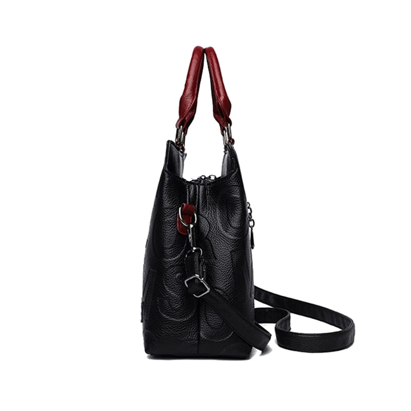 Black crossbody handbag in style1 style2 made of textured black pu leather with contrasting red handles and a detachable shoulder strap.