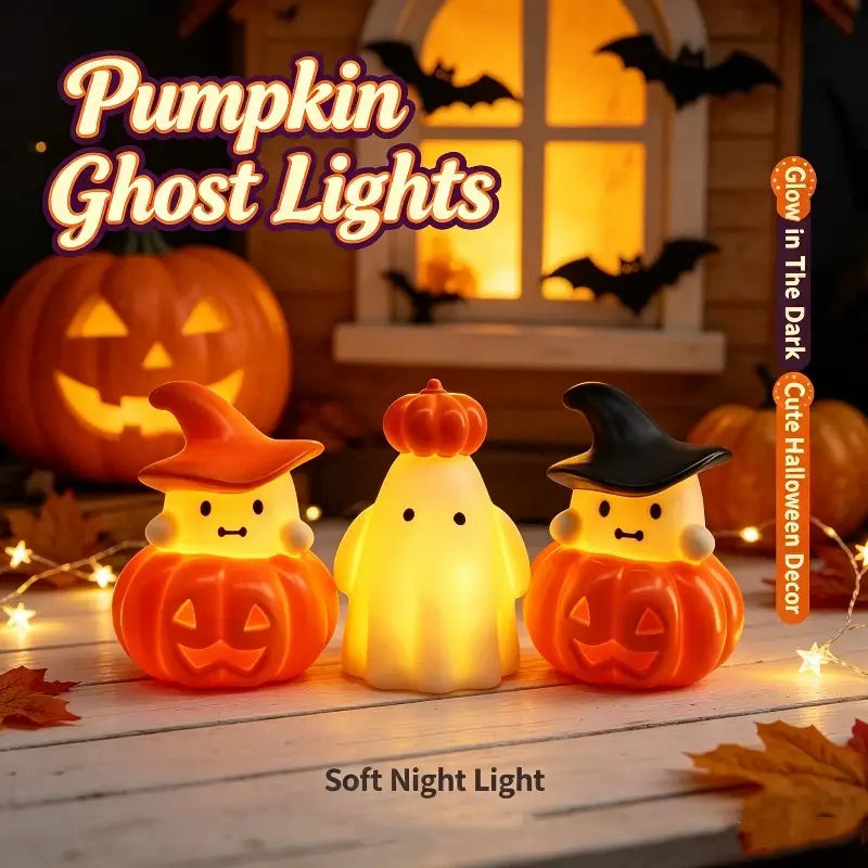 Three glowing halloween pumpkin ghost night light ornaments featuring orange and yellow translucent plastic bodies with carved jack o lantern faces.
