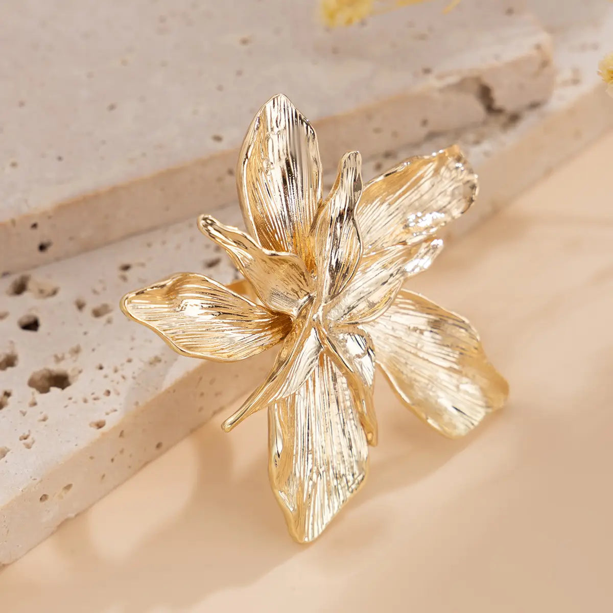 adjustable double layer flower ring featuring a gold-colored intricately textured brooch with detailed petal design