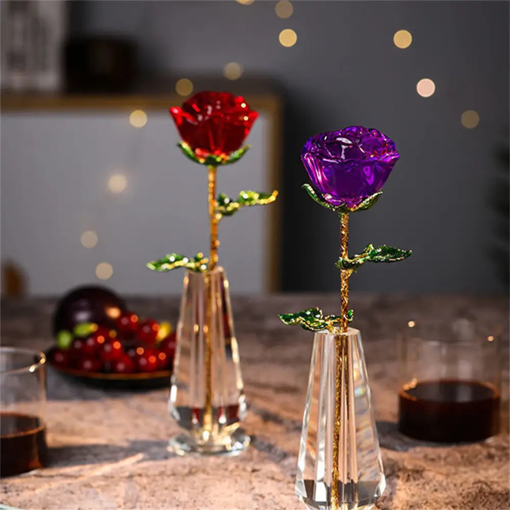 Two crystal-clear glass vases each holding a jeweled rose with one vibrant red and one deep purple flower featuring gold-leaf stems and green enamel leaves ideal for a crystal glass rose gift for Valentine’s Day.