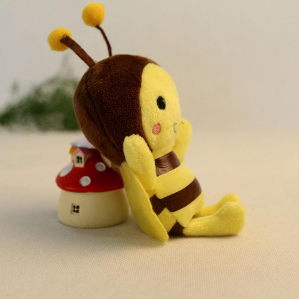 a bee stuffed animal plush toy with a yellow and brown fuzzy body, black eyes, pink cheeks, and bright yellow-tipped antennae made of soft material