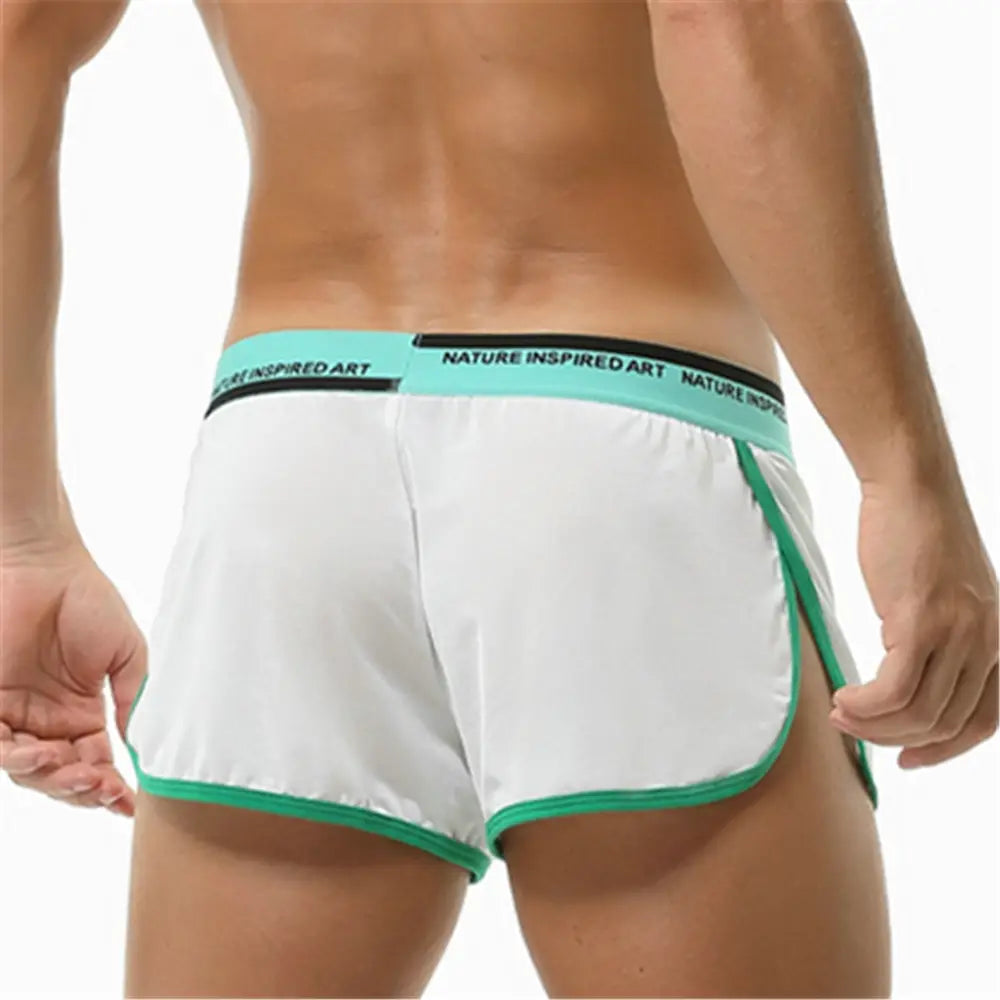 Boxer briefs para hombre transpirables, atléticos y de dormir, de color blanco, con ribetes turquesa y negro, y un diseño de pretina con arte inspirado en la naturaleza.