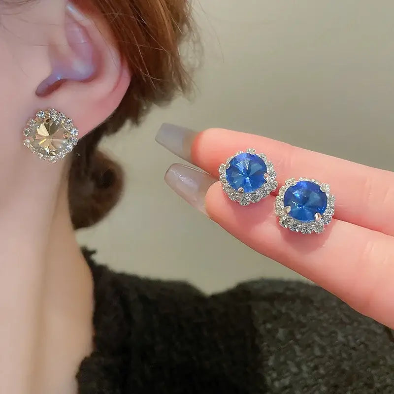A pair of sparkling blue and clear crystal stud earrings with a silver-toned metal setting from the crystal necklace and earring set pink ab wedding jewelry.