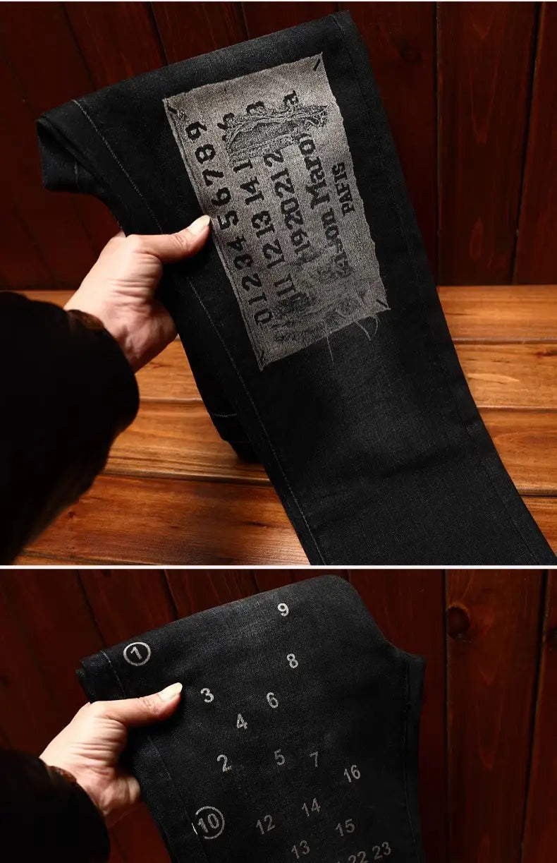 Mens slim fit printed black denim jeans in black featuring a vintage-style patch with embossed numbers and levi’s paris branding on the back side.
