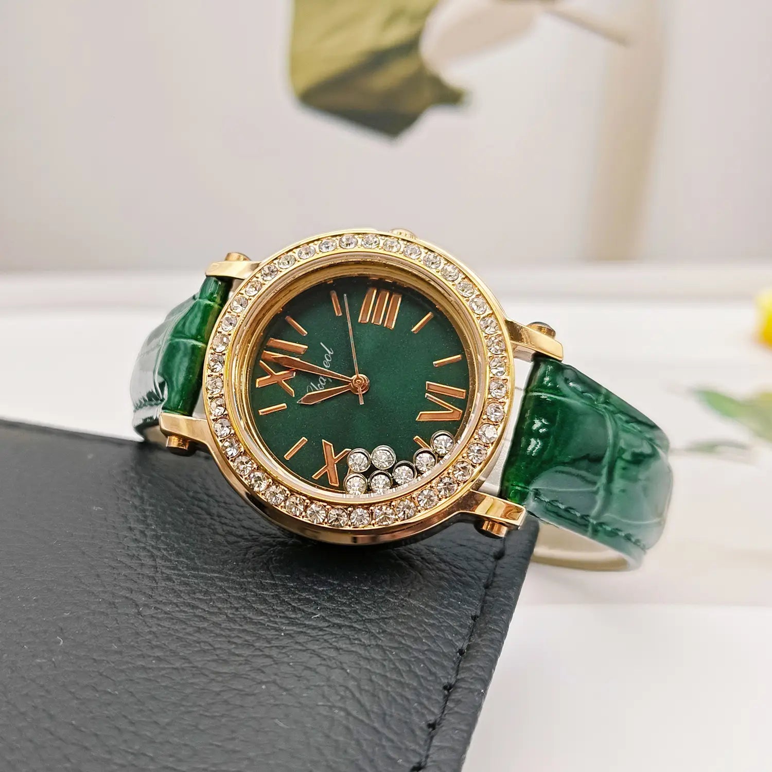 Emerald green crocodile-patterned leather strap women watch with gold-tone case and diamond-encrusted bezel featuring roman numerals.