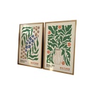 Two framed Matisse flower prints with stylized green blue and orange botanical illustrations on cream backgrounds