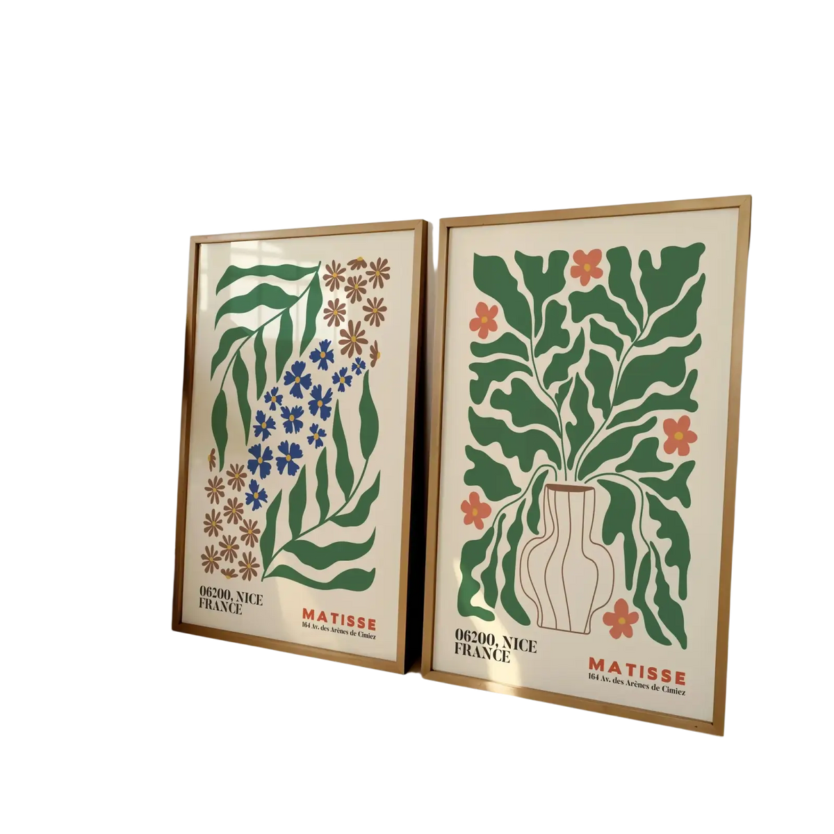 Two framed Matisse flower prints with stylized green blue and orange botanical illustrations on cream backgrounds