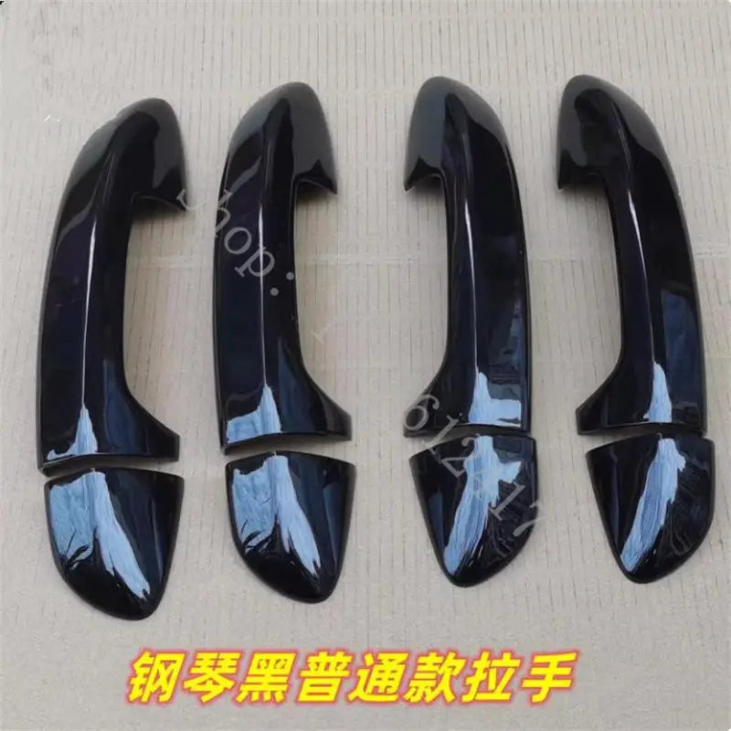 Set of four glossy black piano black vw passat door handle cover trims in carbon fiber with a sleek and modern design.