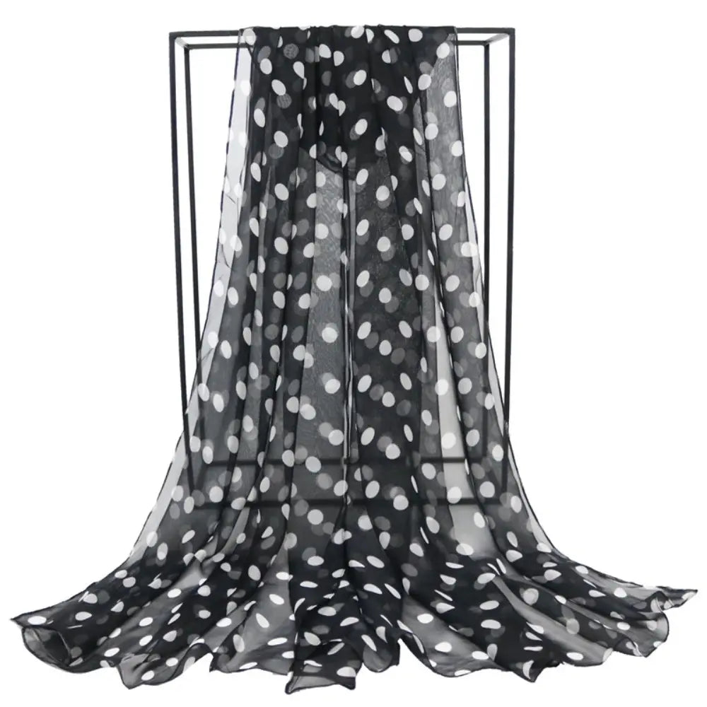 Black sheer silk head wrap scarf with white polka dots showcasing a lightweight and elegant design.