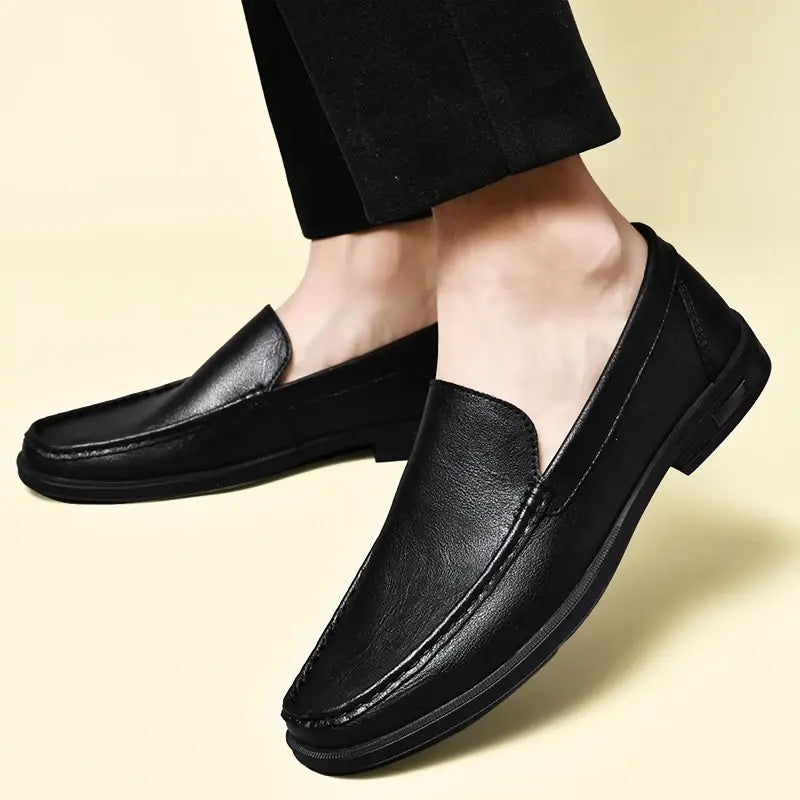 Men genuine leather slip-on dress loafers in black leather with a sleek minimalist design and subtle stitching details.
