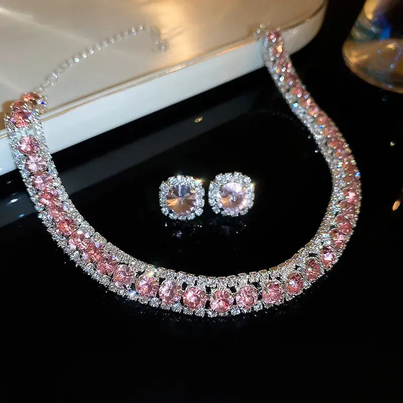 A sparkling pink and silver crystal necklace and earring set featuring a double-row design of faceted rhinestones on a sleek metallic chain ideal for wedding jewelry.