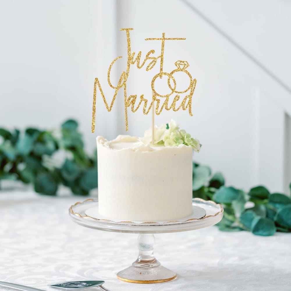 Just married gold glitter cake topper featuring a ring design for wedding decoration.