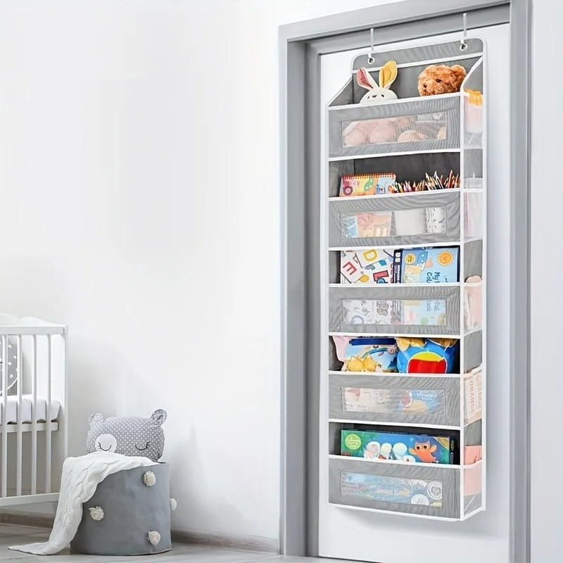 Gray over door hanging storage organizer made of fabric with five transparent mesh pockets and white trim for convenient wall storage.