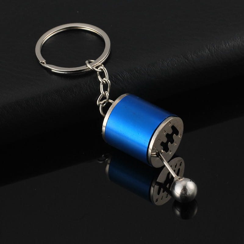 Blue metallic manual gear shift car keychain with silver accents and ball-tipped lever made of metal.