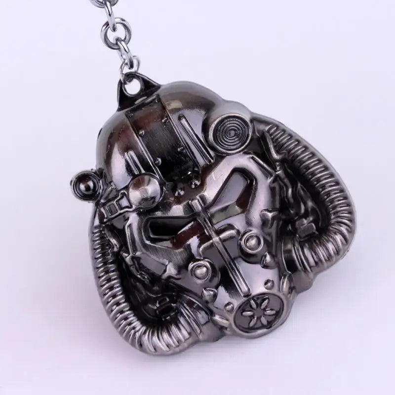 fallout power armor helmet keychain featuring a detailed metallic silver pendant shaped like a futuristic gas mask with intricate mechanical details and ribbed tubing