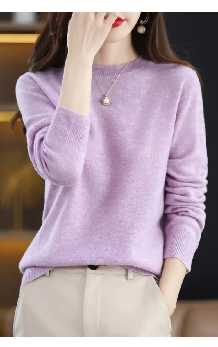 A soft lavender pure wool cashmere o-neck pullover sweater with long sleeves and a round neckline.