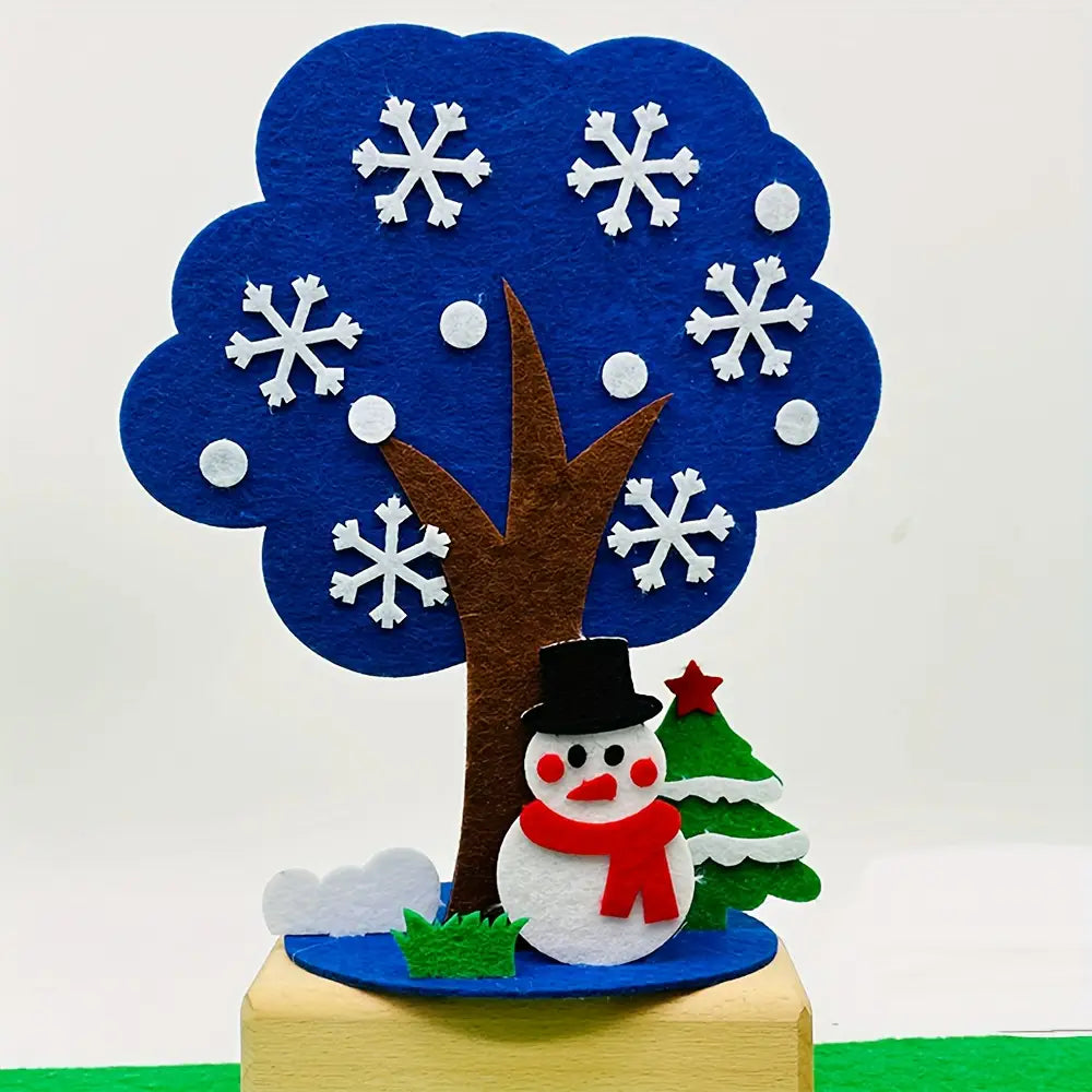 kit de manualidades estacionales de árbol de fieltro tipo diy festivo que incluye una figura de muñeco de nieve de fieltro con un gorro de copa negro y una bufanda roja, debajo de un árbol de fieltro azul decorado con copos de nieve blancos.