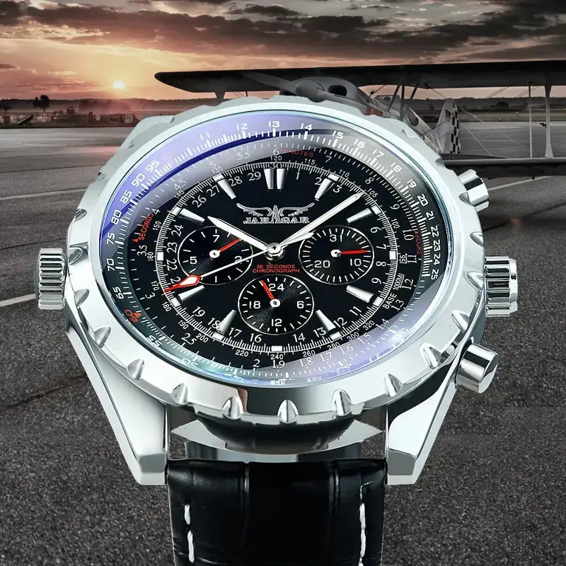Mechanical stainless steel men’s chronograph watch with a silver case, black dial, red accents on the hands and subdials, and a black leather strap.