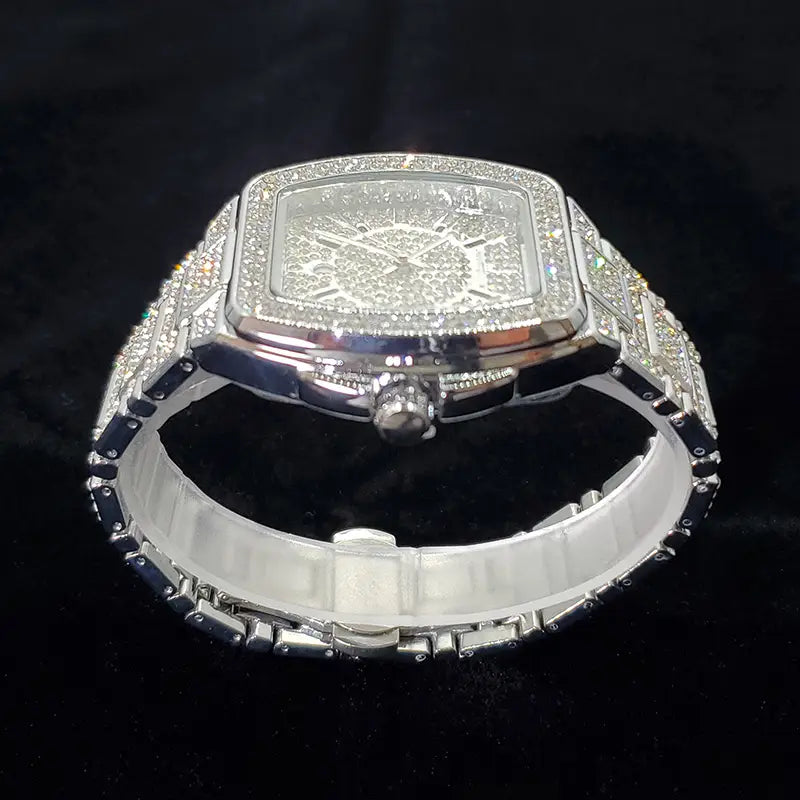 A dazzling silver gold iced out square diamond mens watch luxury quartz with a square face and bezel encrusted in sparkling crystals featuring an intricate diamond-embedded dial and a matching crystal-adorned bracelet.