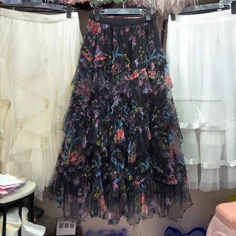 Falda de tul floral fairycore negra con ribete de perlas, con detalles delicados de encaje y tejido translúcido que fluye.