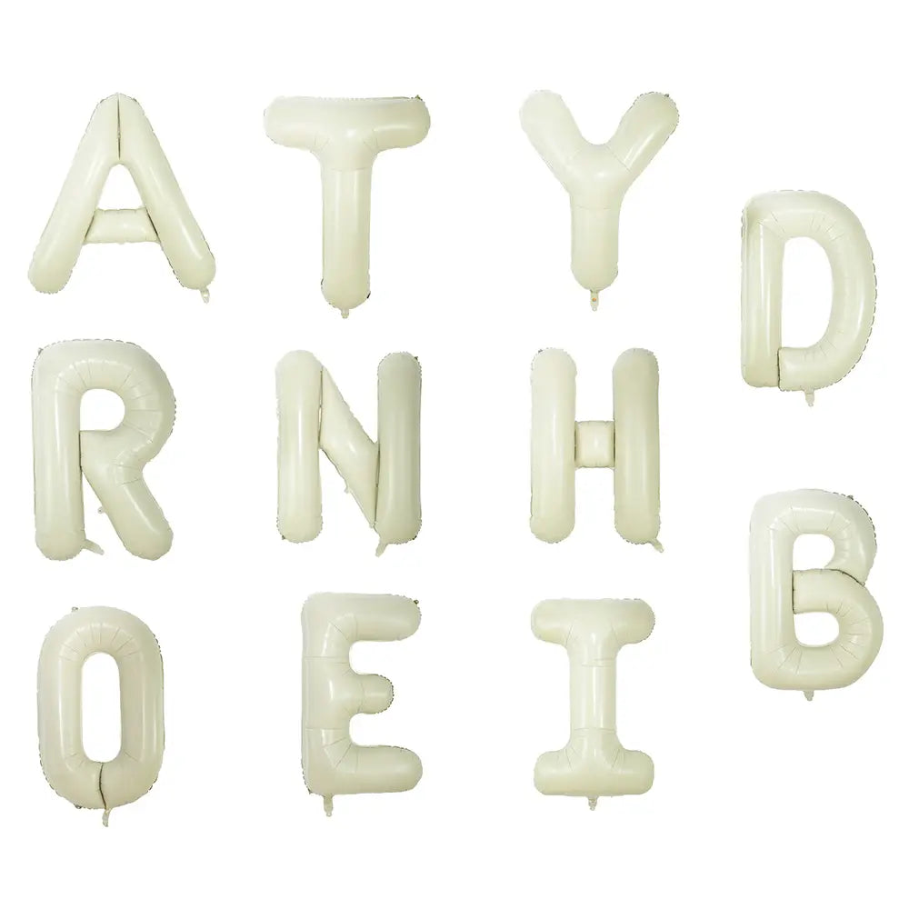 Cream white 40 inch letter foil balloons made of glossy foil are arranged in a grid displaying their off-white color and letter-shaped design.