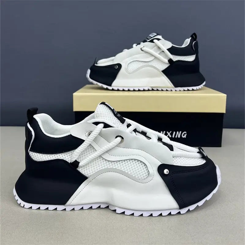 Men orthopedic slip-on walking shoes in black and white featuring chunky design with mesh panels and rubber sole for enhanced comfort and support.