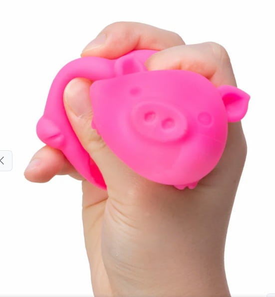 a bright pink squishy pig-shaped sensory fidget toy made of soft silicone designed as the needoh digging pig stress reliever.