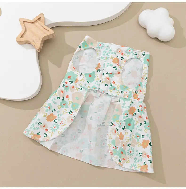 Floral dog princess dress with bow featuring a delicate light green and orange floral pattern made of sheer airy fabric.