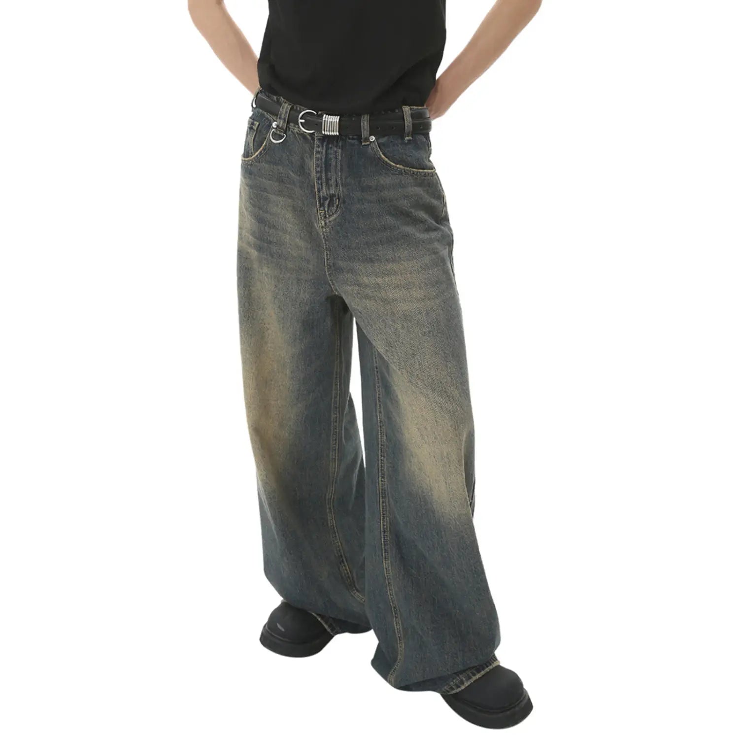 Men’s vintage wide leg baggy denim jeans in faded distressed blue with a black belt and silver-toned buckle.