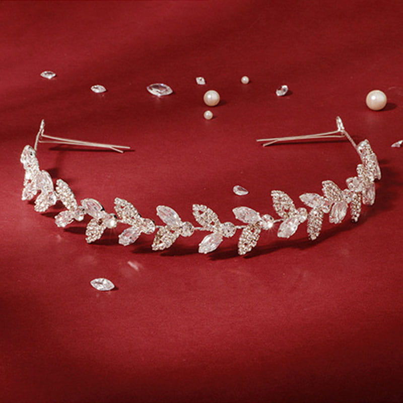 A delicate silver crystal leaf bridal headband adorned with sparkling clear crystals and small pearls for wedding hair accessory.