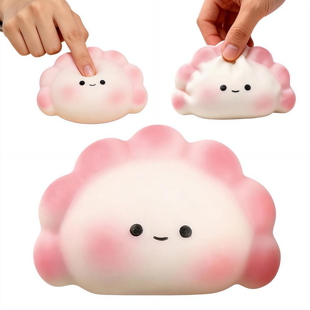 peluche suave de color rosa y blanco con forma de dimsum para aliviar el estrés, con una linda carita sonriente, diseñado como una bola exprimible tipo fidget