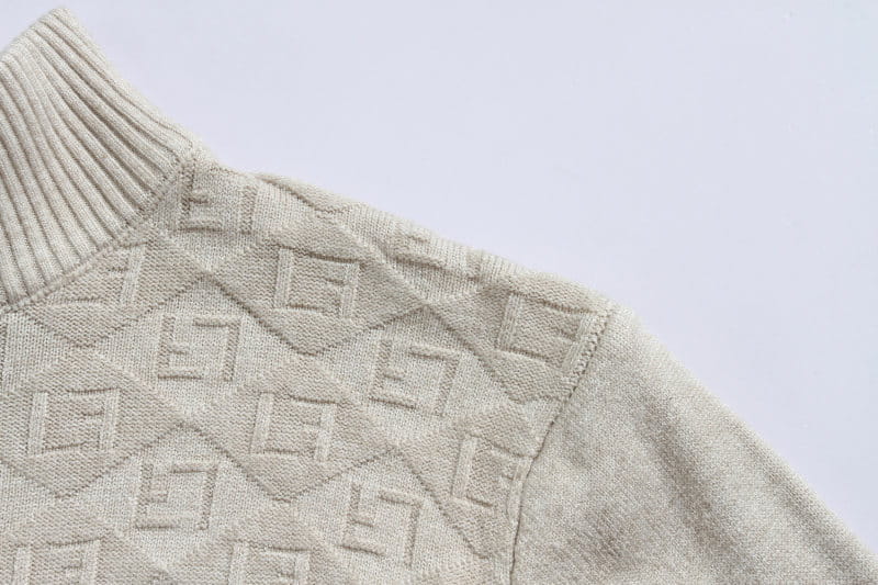 Beige knitted plus size mens half zip cable knit sweater with ribbed crew neck and repeating geometric pattern.