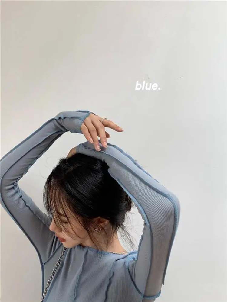 Ein hellblauer gerippter Longsleeve-Top für Damen mit transparenter Textur und schlankem Casual-Fit.