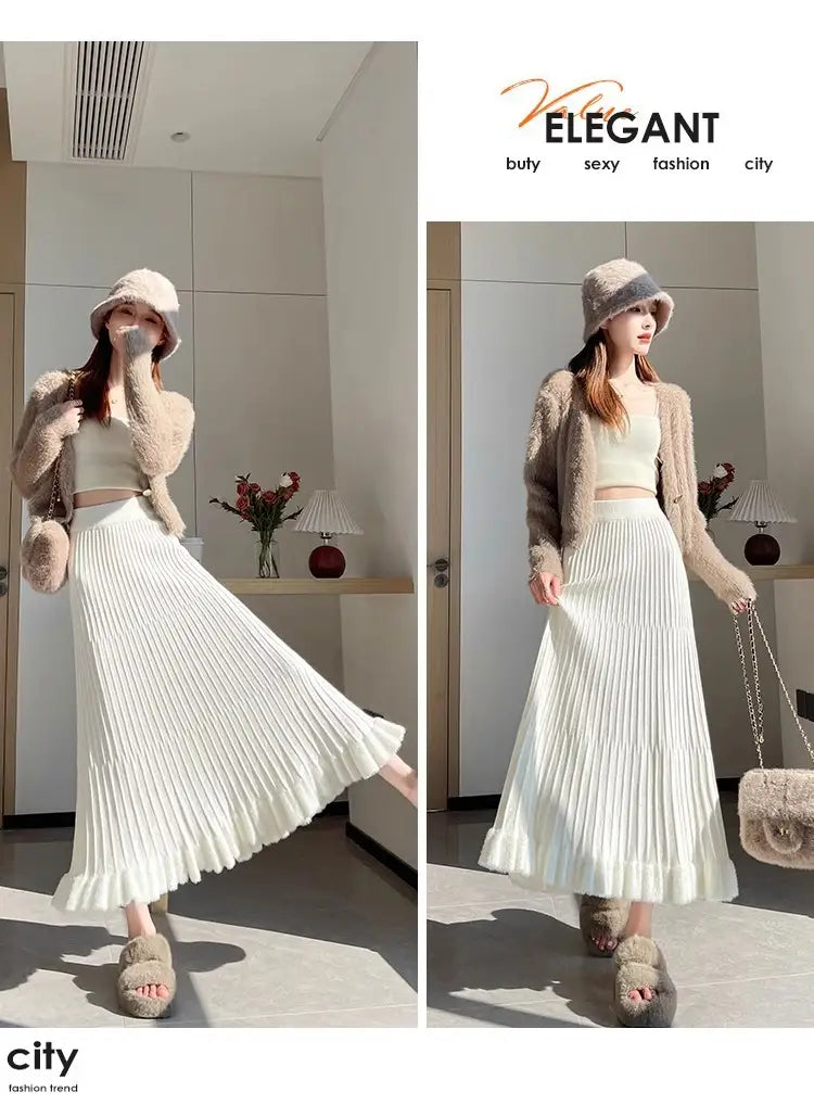 Une jupe mi-longue en maille blanche fluide, avec plis à taille haute et tissu à texture douce, dans un style parapluie.