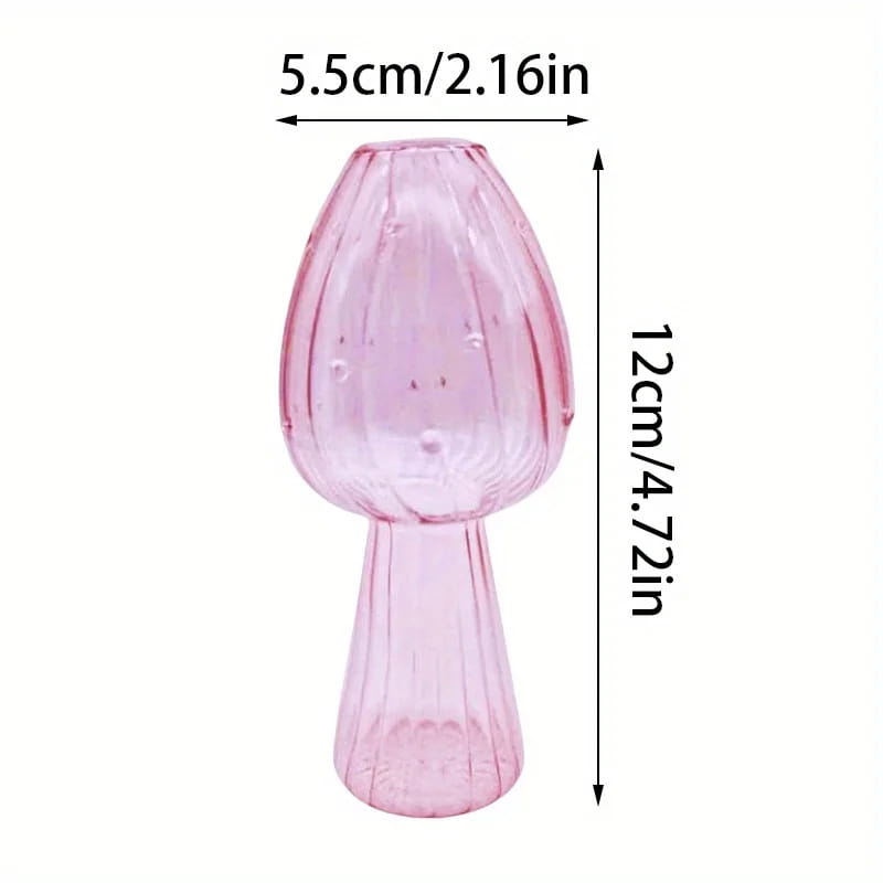 A translucent pink glass mushroom-shaped bud vase with ribbed texture and slender stem designed as a colorful Nordic plant holder.