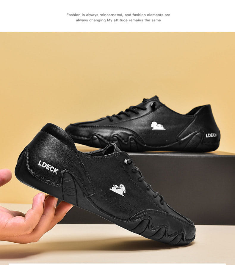 baskets décontractées en cuir noir pour homme, dotées d’un design ldeck décontracté en daim gris, avec un logo brodé blanc et une semelle texturée.