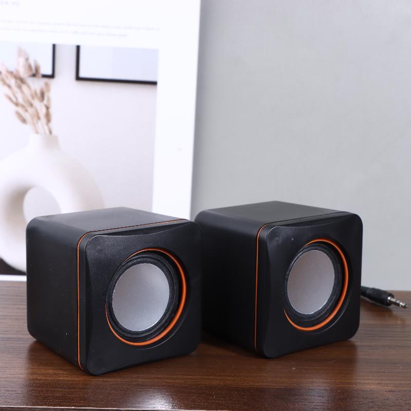 black cube-shaped usb computer speakers with orange trim and led stereo drivers for desktop pc audio use