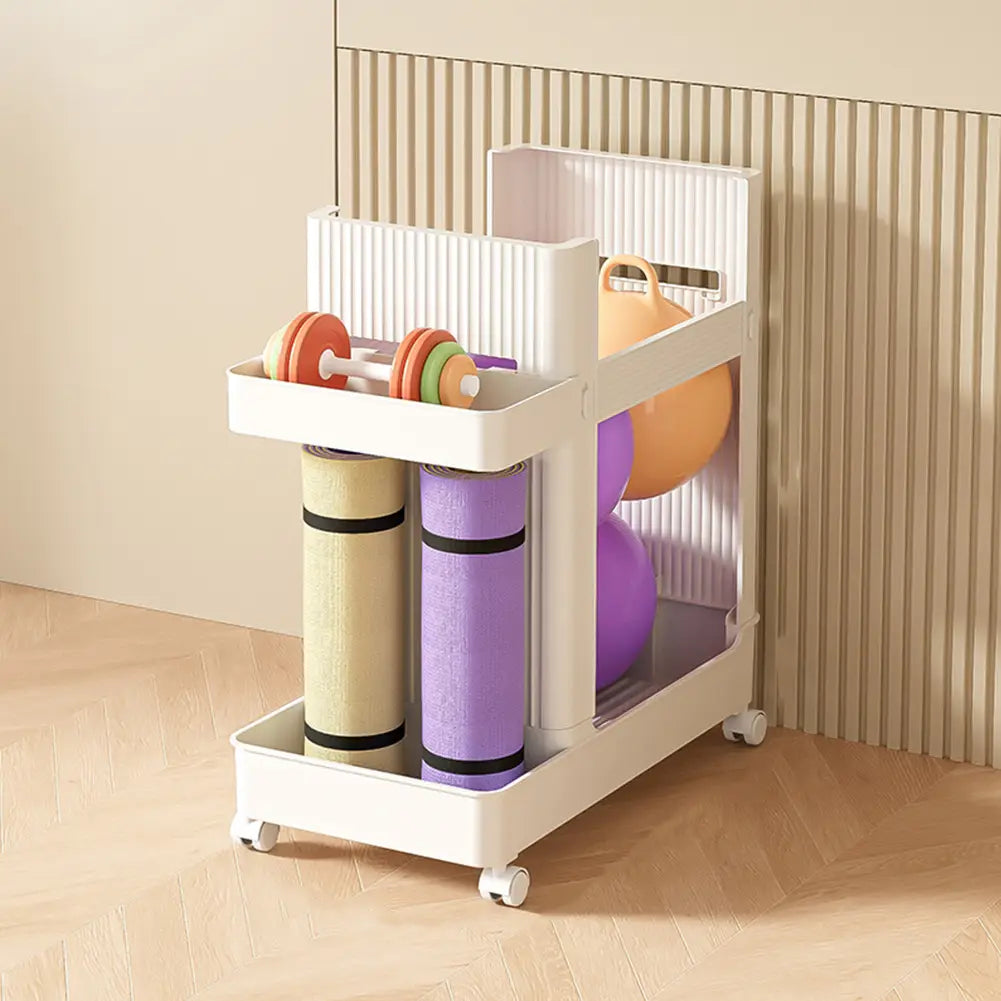 White plastic two-tiered gym equipment organizer trolley with wheels featuring a top shelf with colorful dumbbells and an orange exercise ball and a lower compartment with beige and purple rolled yoga mats.