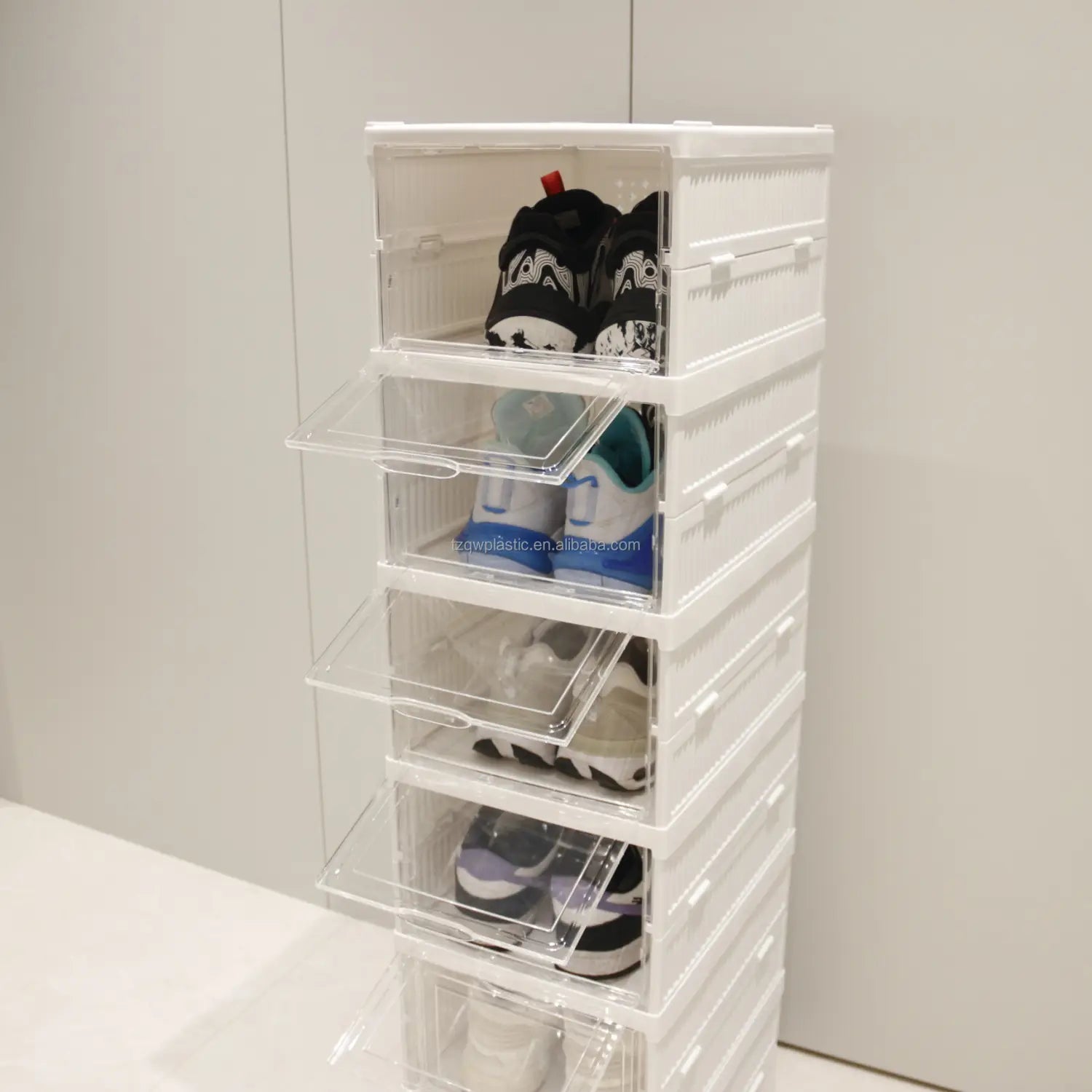 stacked white plastic storage boxes with clear lids designed as a shoe organizer holding sneakers for efficient working time use.