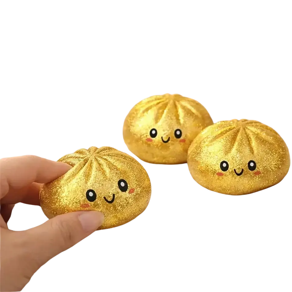 Golden glittery dumpling shaped squishy stress relief toy with smiling faces in box perfect gift for fans