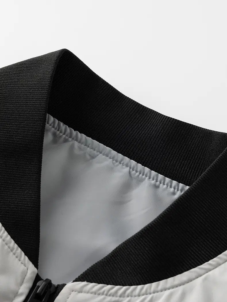 black ribbed collar with silver lining on a white waterproof hiking jacket windbreaker for men designed for autumn hiking