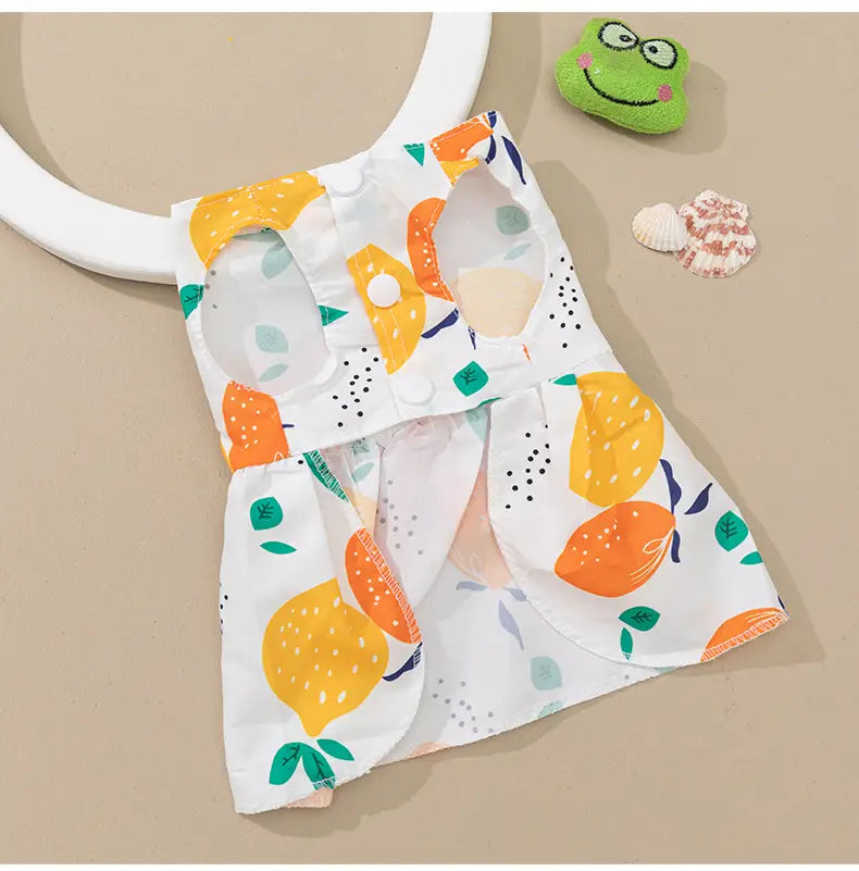 White pet vest with a playful citrus fruit pattern in orange yellow and green featured in the floral dog princess dress with bow product.