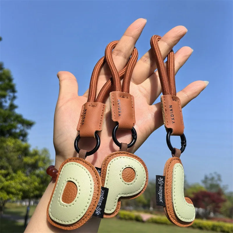 A To Z Leather Initials Keychain Braied Wristband Pendant Keyring for Women Men Car Bag Charms Camera Phone Case Accessories