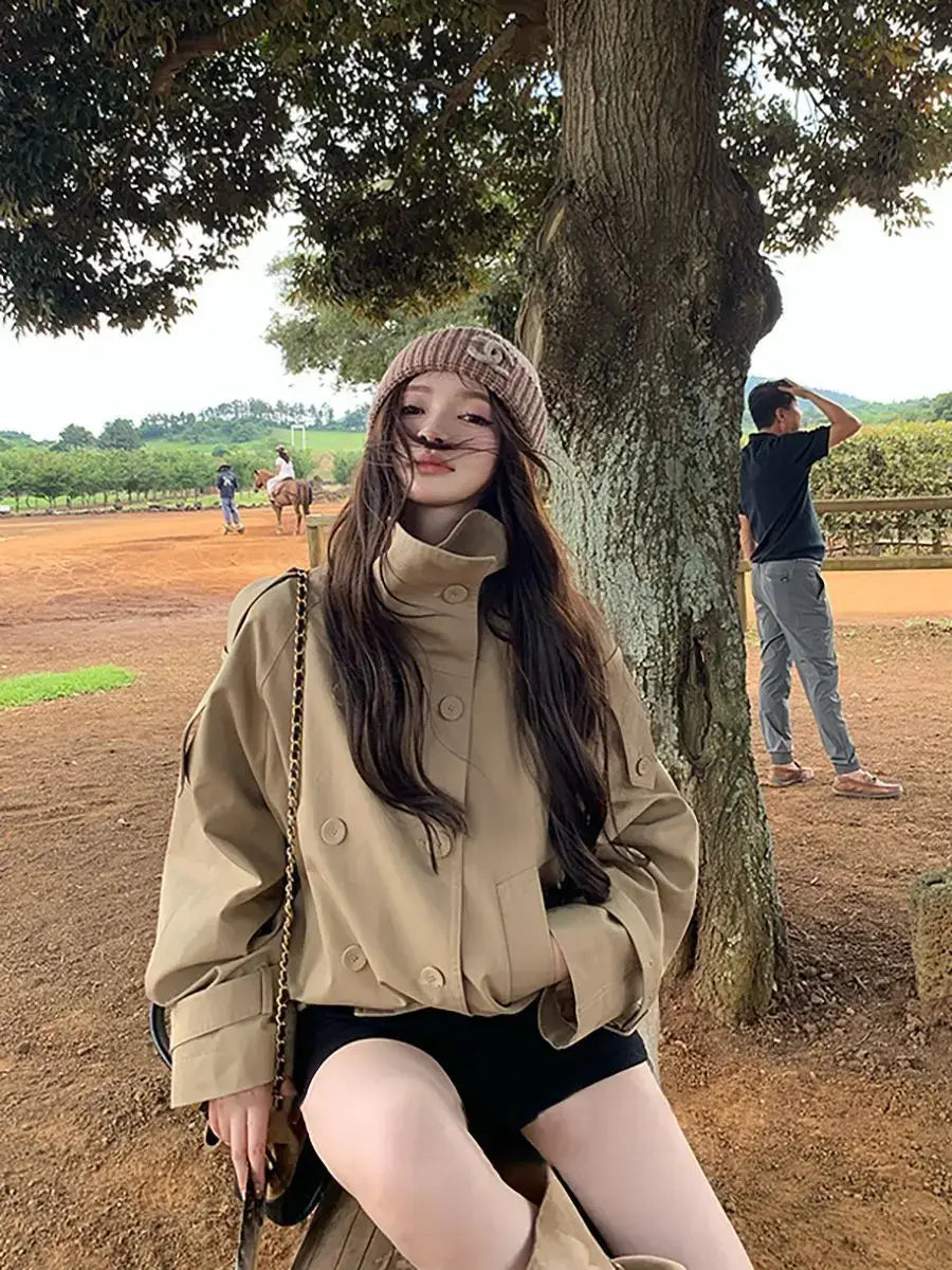 Beige Korean style trench coat featuring a high collar and double-breasted button closure designed as a utility jacket.