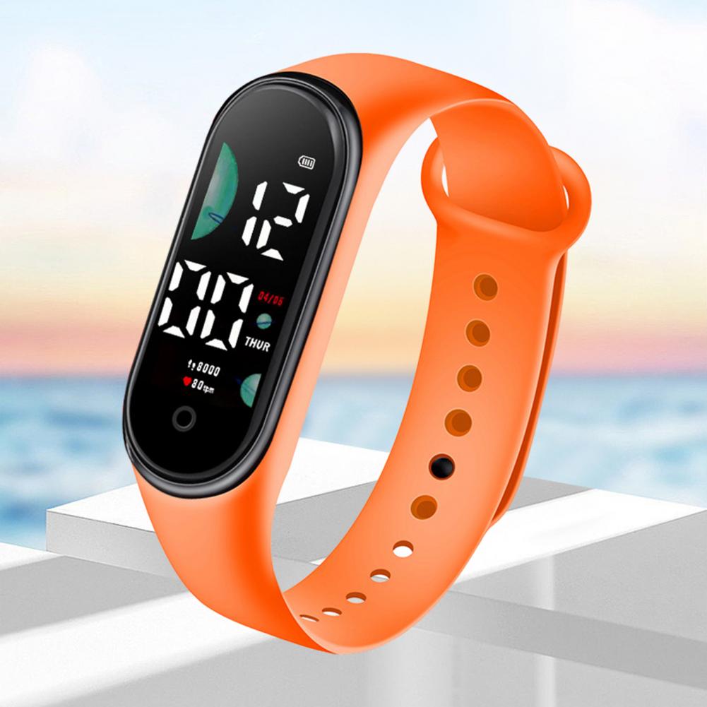 Bright orange silicone electronic watch with a large font screen and black digital display showing time and fitness metrics for sports use.