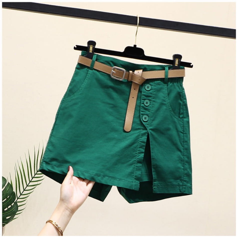 Emerald green office lady wide leg shorts featuring a button front with a tan leather belt and silver buckle.