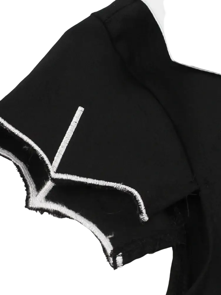 Black fabric sleeve with white stitched design along the frayed edge on tonval bat embroidery halloween vintage dress