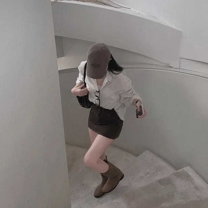 brown suede ankle boot paired with a striped long sleeve button down shirt showcasing versatile style and standard thickness fabric for long sleeve wear