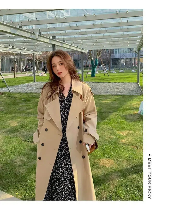 Beige women double-breasted trench coat with black buttons designed as a casual windbreaker.