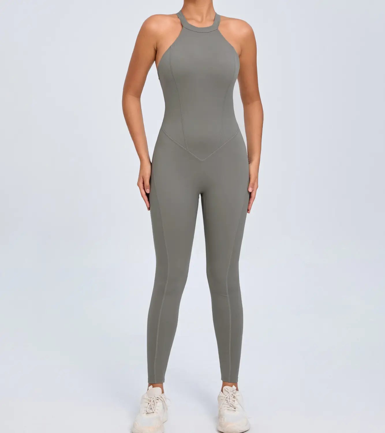 A sleek olive-green high-neck one-piece athletic jumpsuit with a form-fitting design and seamless construction for workout use.